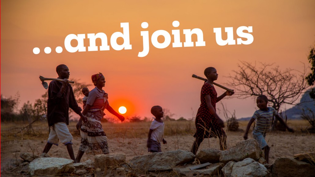 Sunset image with a family walking through a working field