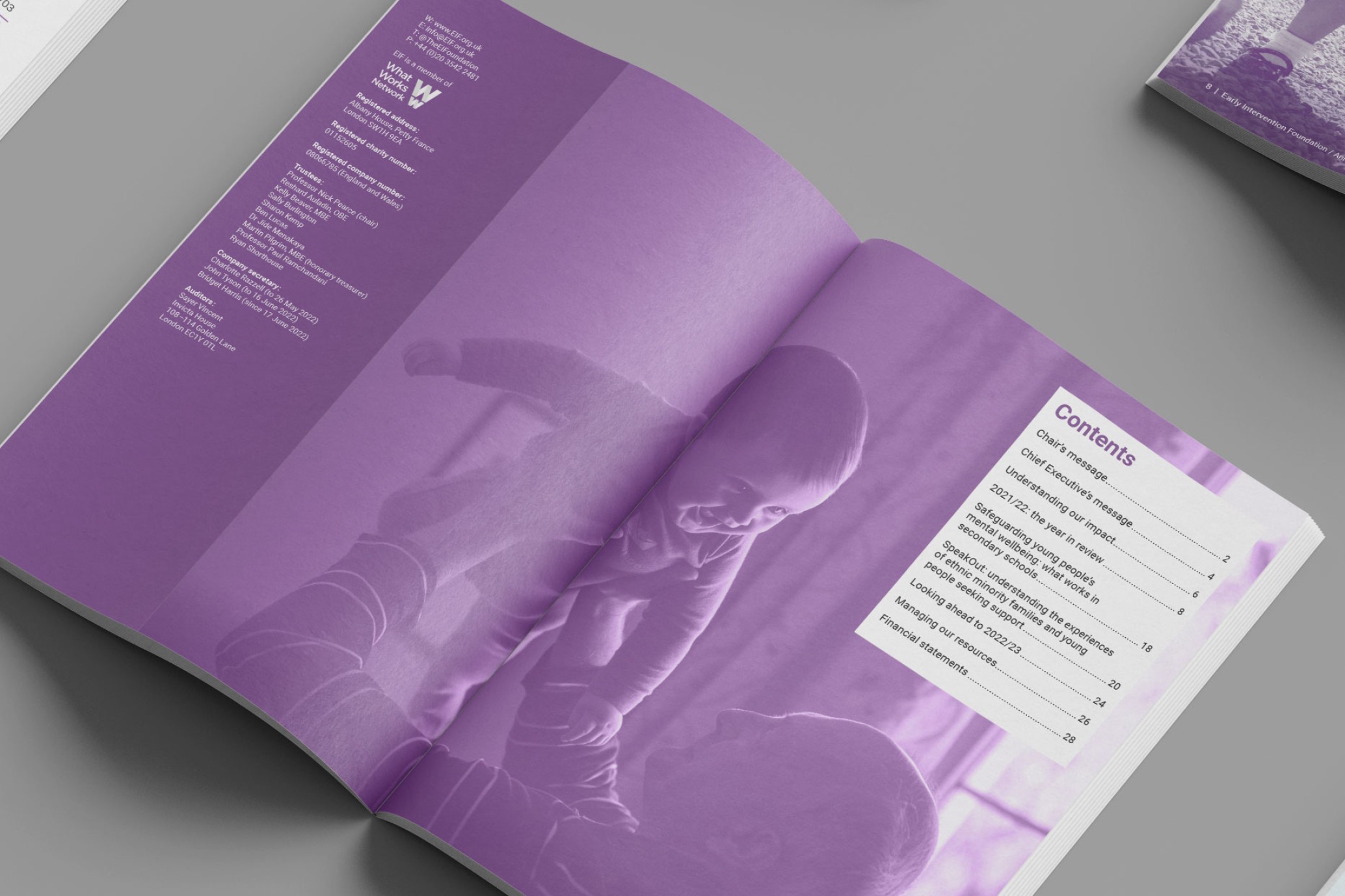 An image of an open report showing contents and image of an elderly man holding up a smiling baby.